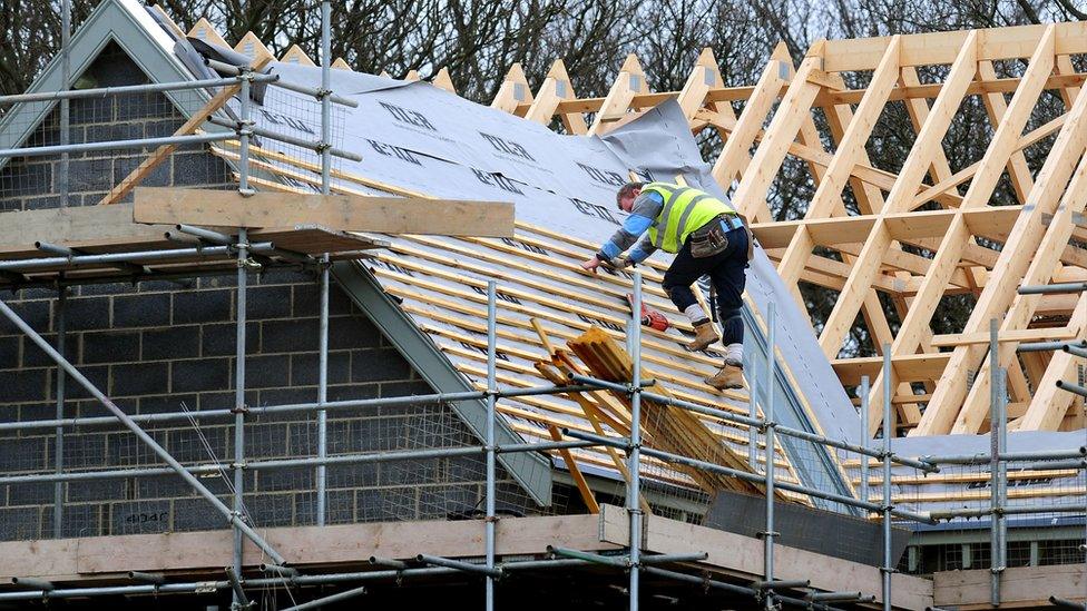 Man on roof of house