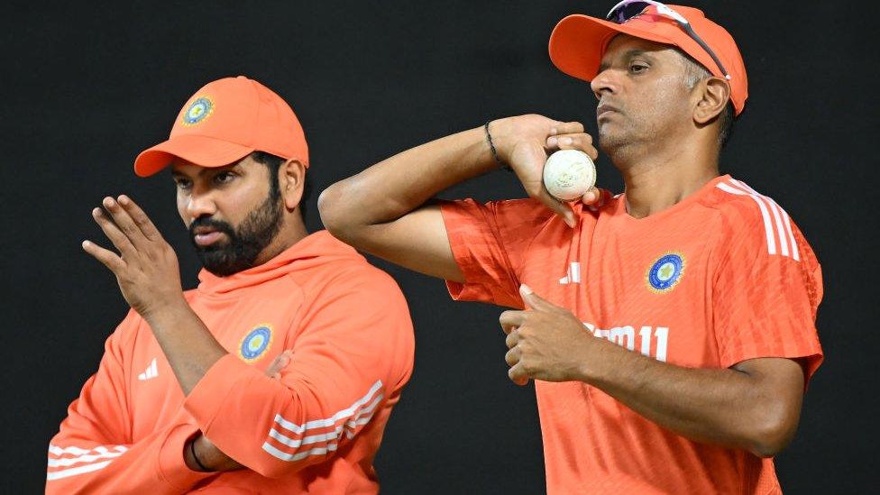 Rahul Dravid, Coach of India looks on with Rohit Sharma of India during the ICC Men's Cricket World Cup India 2023 at Narendra Modi Stadium on November 18, 2023 in Ahmedabad, India.