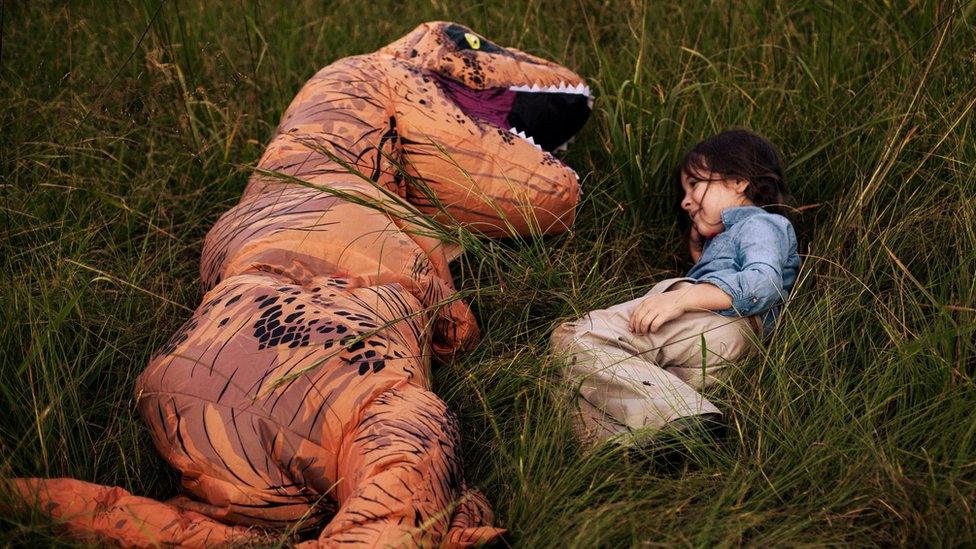 Levi (left) with his cousin Lola (right). Levi picked the T.rex costume for the family photo shoot after finding previous portraits overwhelming