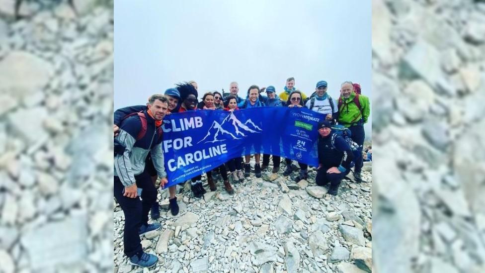 The Climb For Caroline team at the top of a peak