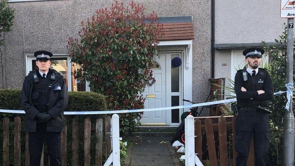 Police officers outside house