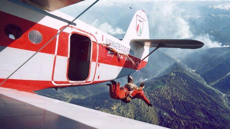 A serviceman from Russia's forest protection is parachuted from a plane in Krasnoyarsk region, Russia. Photo: 1 August 2019