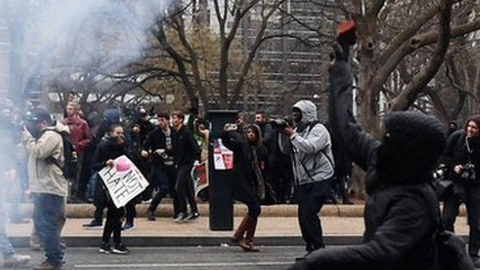 A protester lobs a brick at police during protests in Washington during the inauguration of Donald Trump