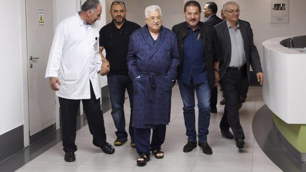 Image released by Mahmoud Abbas's office showing the president (centre) walking in a hospital corridor (21/05/18)