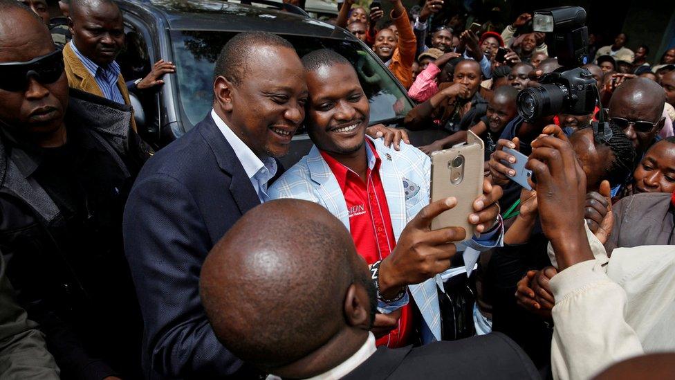 Kenya President Uhuru Kenyatta posing with a voter - 26 October 2017