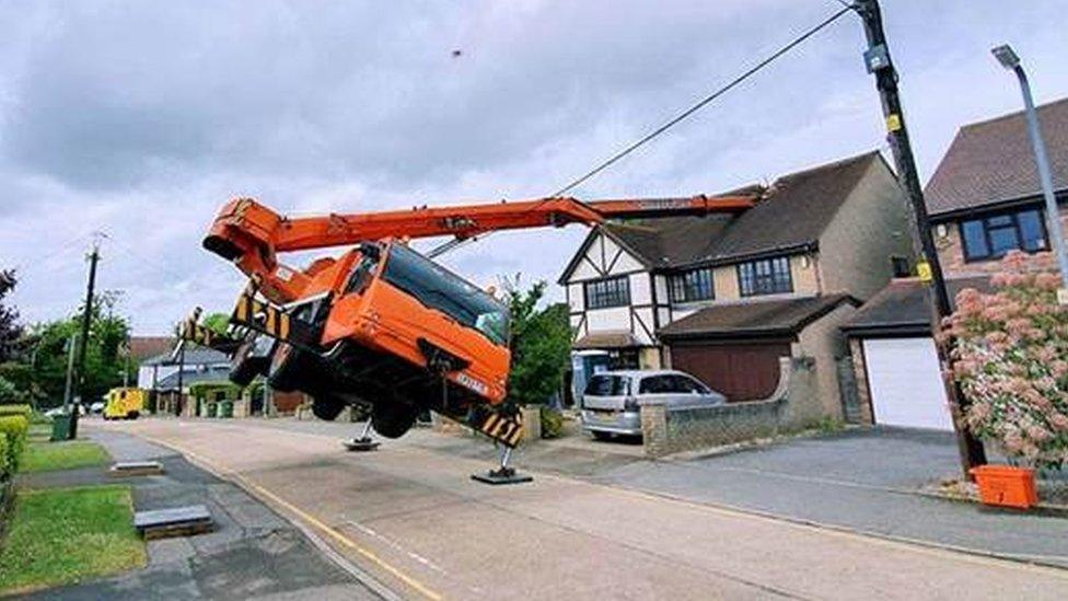 A crane tipped through a house