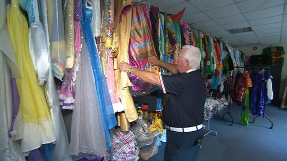 Owen Money looking at pantomime costumes