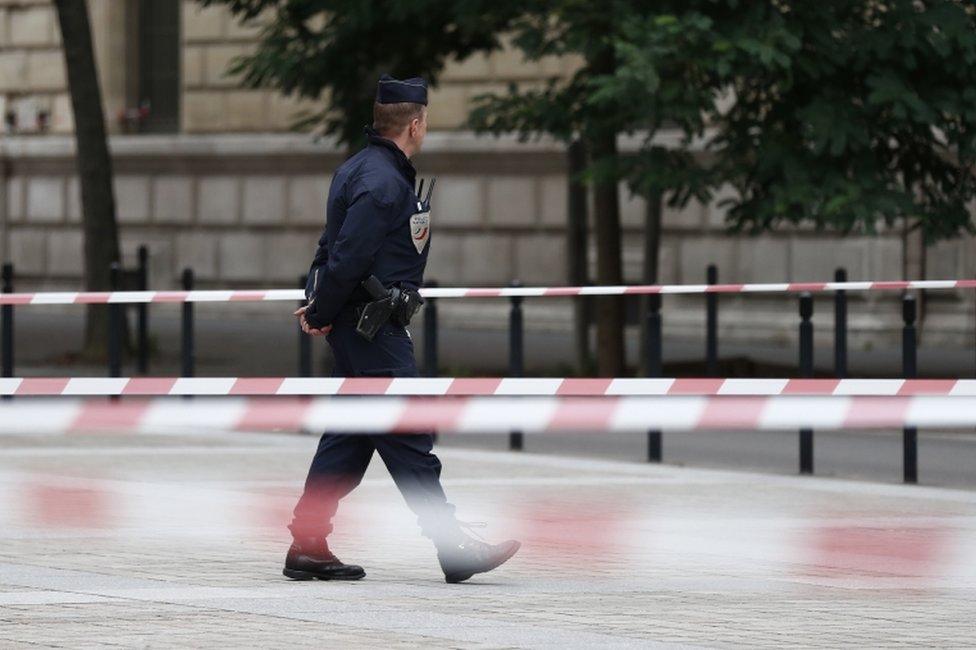 French police and security forces establish a security perimeter near Paris police headquarters.