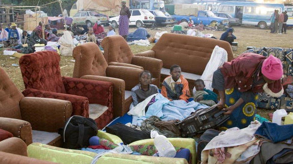 People, fleeing the wave of violence that has left at least 360 people dead and displaced 250,000 following the presidential elections, sit next to their belongings at Langata police station where Internally Displaced People (IDP's) seek refuge outside El Doret, western Kenya, 05 January 2008