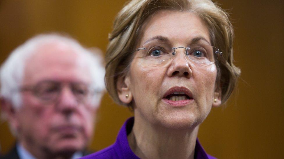 Elizabeth Warren and Bernie Sanders appear together at a news conference.