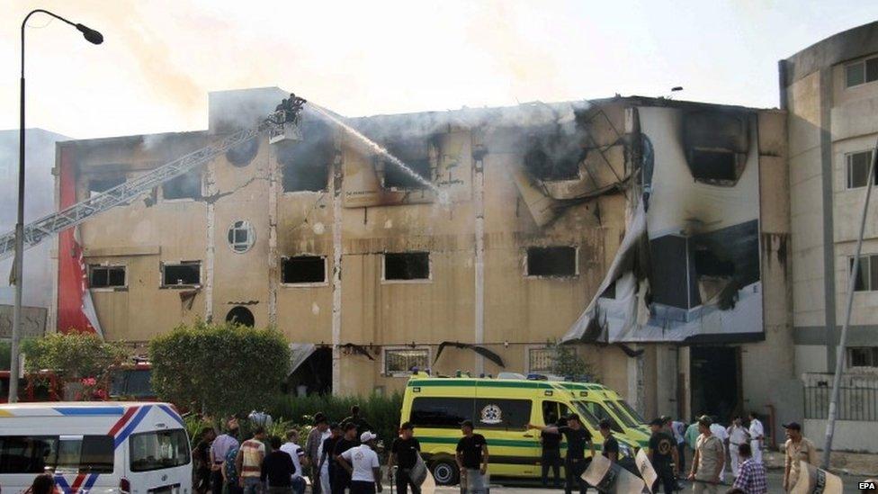 Egyptian emergency services battle a fire at a factory near Cairo