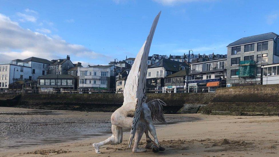 Angel statue on beach.