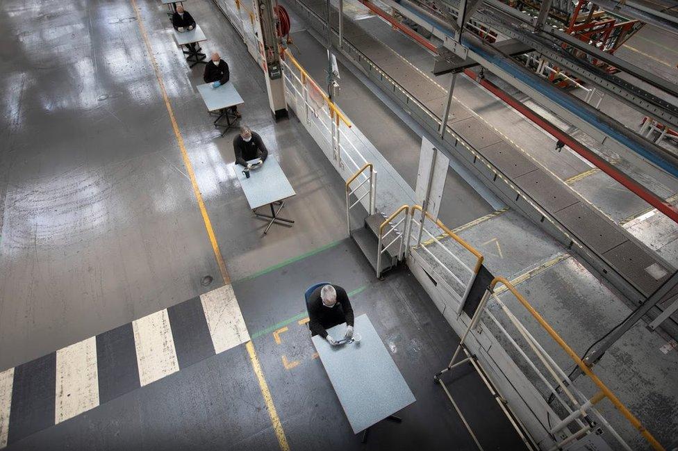 Aerial view of workers taking break on separate tables