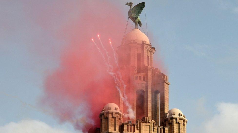 Flares spark out from the top of the Liver Building