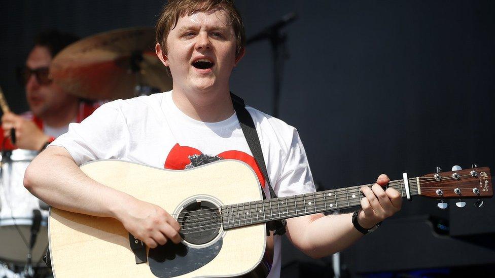 Lewis Capaldi plays his guitar at Glastonbury