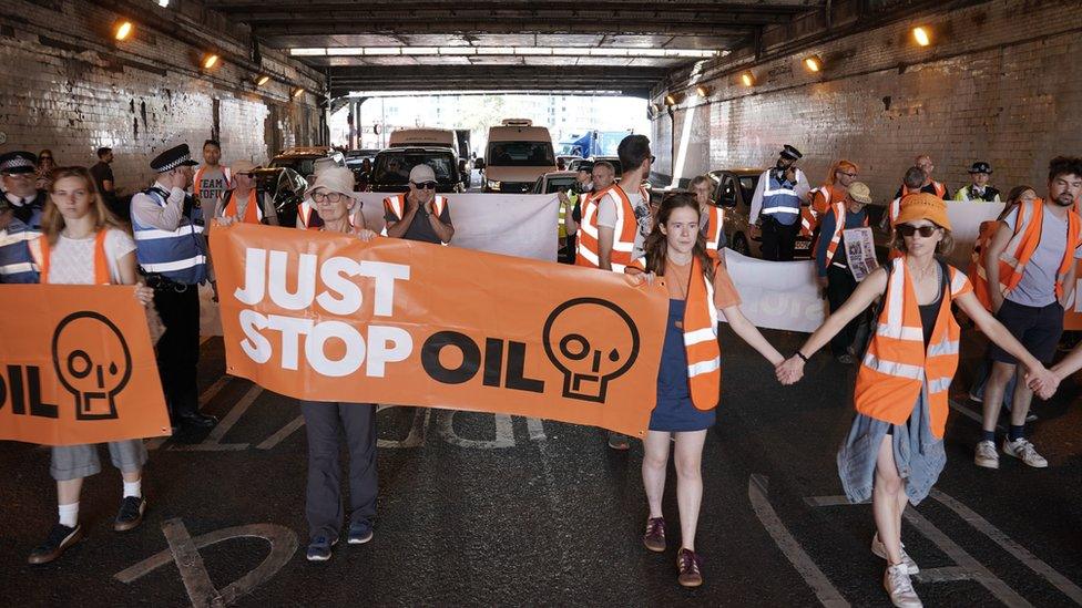 Just Stop Oil activists take part in slow walk protest in Vauxhall, central London