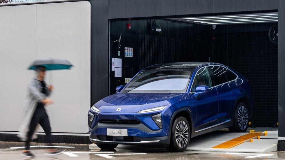 A Nio EC6 electric sport utility vehicle (SUV) is seen at a NIO battery swap station on September 18, 2021 in Xi an, Shaanxi Province of China.