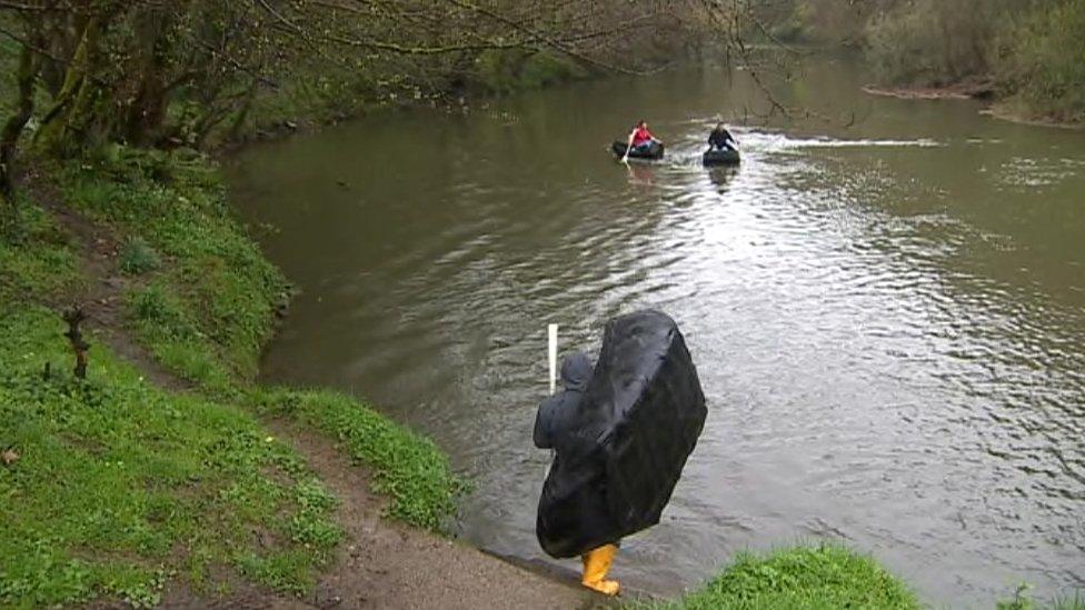 Fishermen catch sea trout in their traditional coracle boats on the River Teifi