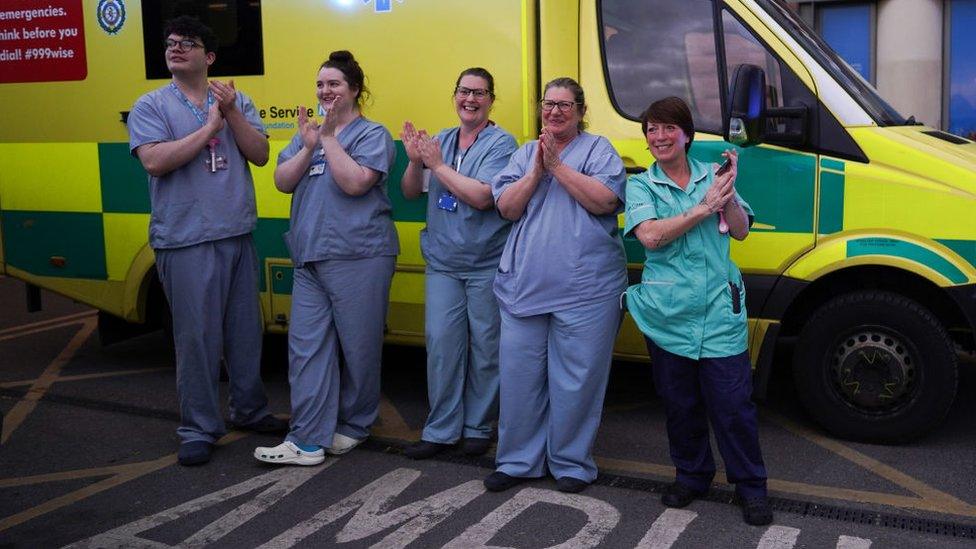 NHS staff gather outside James Cook University Hospital in Middlesbrough to r