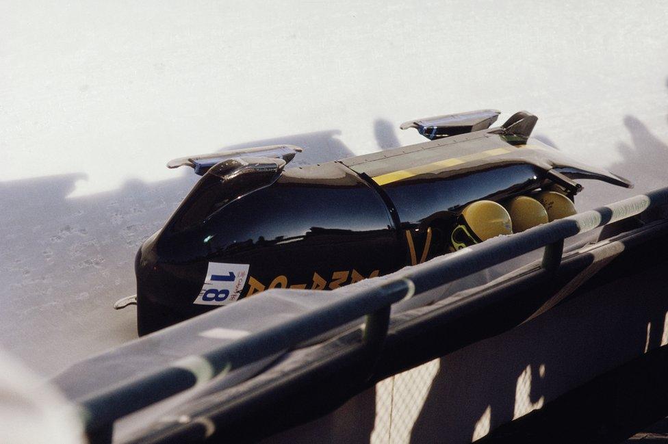 A bobsled turned over onto its side.