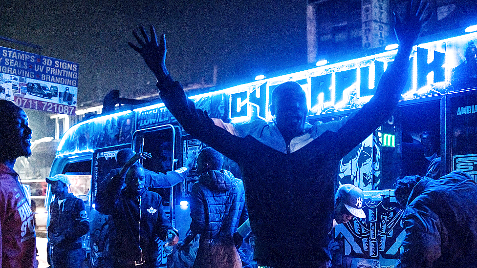 A matatu operator calls for passengers late at night in Nairobi, Kenya - Thursday 21 October 2021