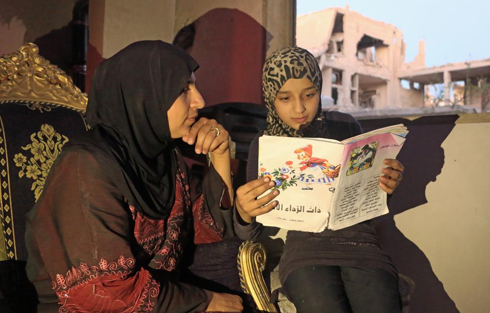 Islam reading to her mother