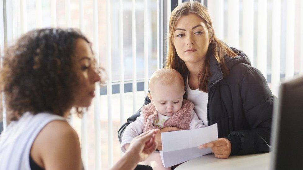 Woman and baby with a benefits officer