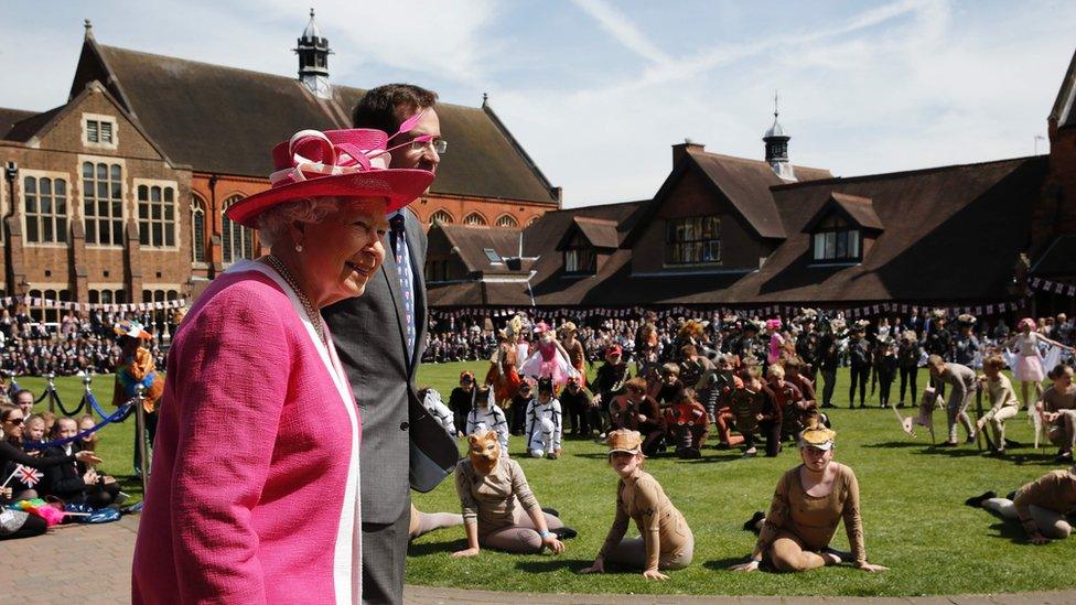 The Queen and Berkhamsted School Principle, Richard Backhouse watching a performance of The Lion King during her visit to Berkhamsted School on May 6, 2016