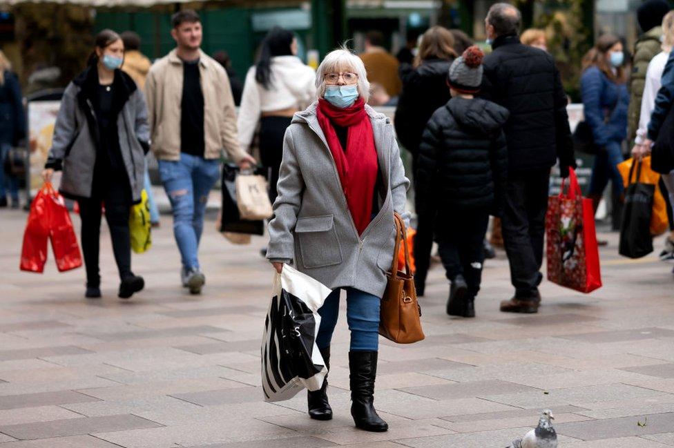 Shopper keeping her distance from others