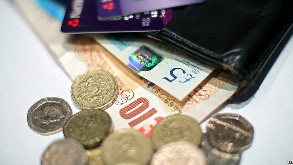 Wallet with pound coins and notes