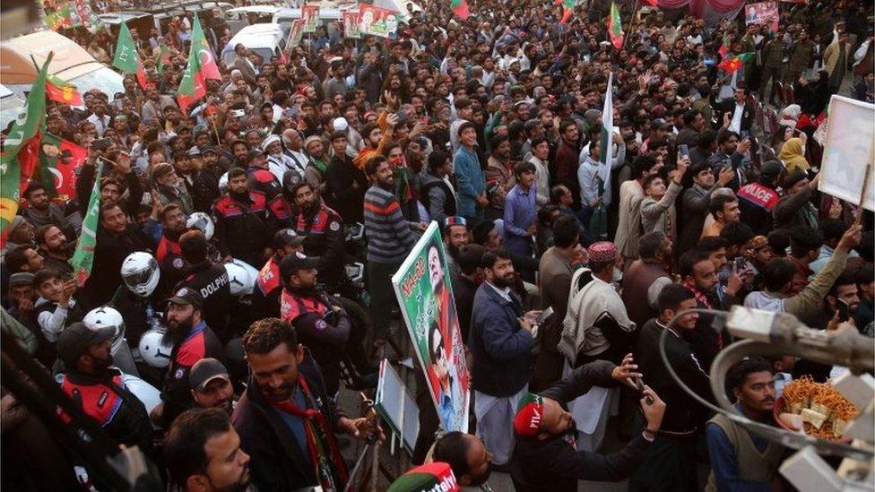 Supporters of former Prime Minister Imran Khan, head of the Pakistan Tehrik-e-Insaf (PTI) party, attend the protest march, as it continues following its resumption days after an assassination attempt on Khan halted the rally, in Rawat, Pakistan, 19 November 2022.