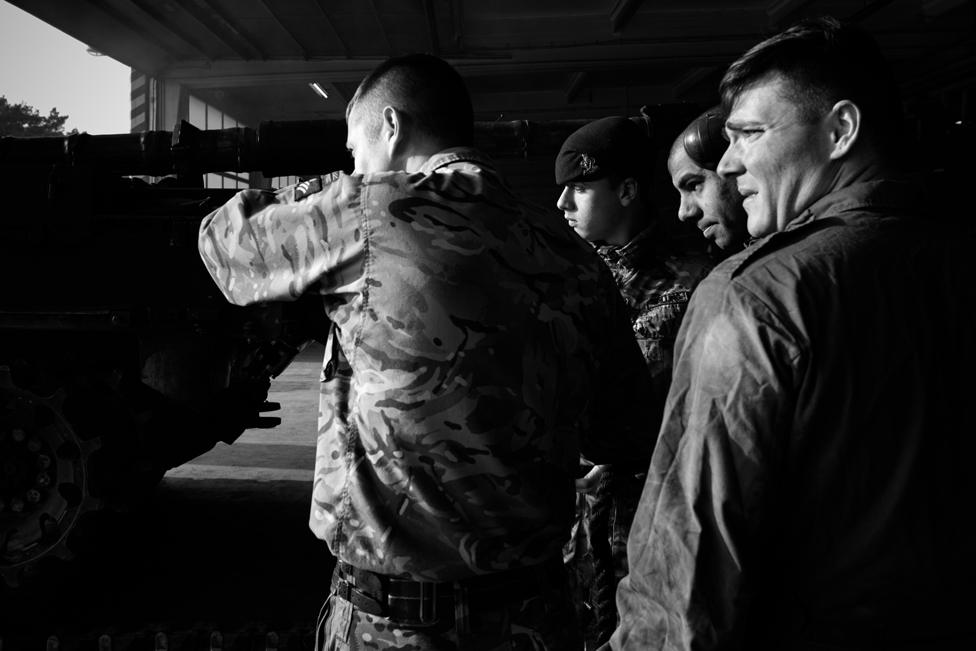 Tank crew from C Squadron of The Queen's Royal Hussars, take a break from maintaining their vehicles in Athlone Barracks, Sennelager, Germany