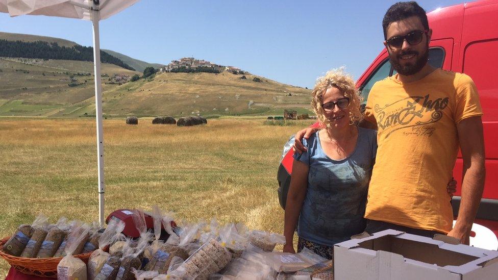 Lorenzo Caponecchi and Monia Falzetti run a stall in the shadow of Castelluccio