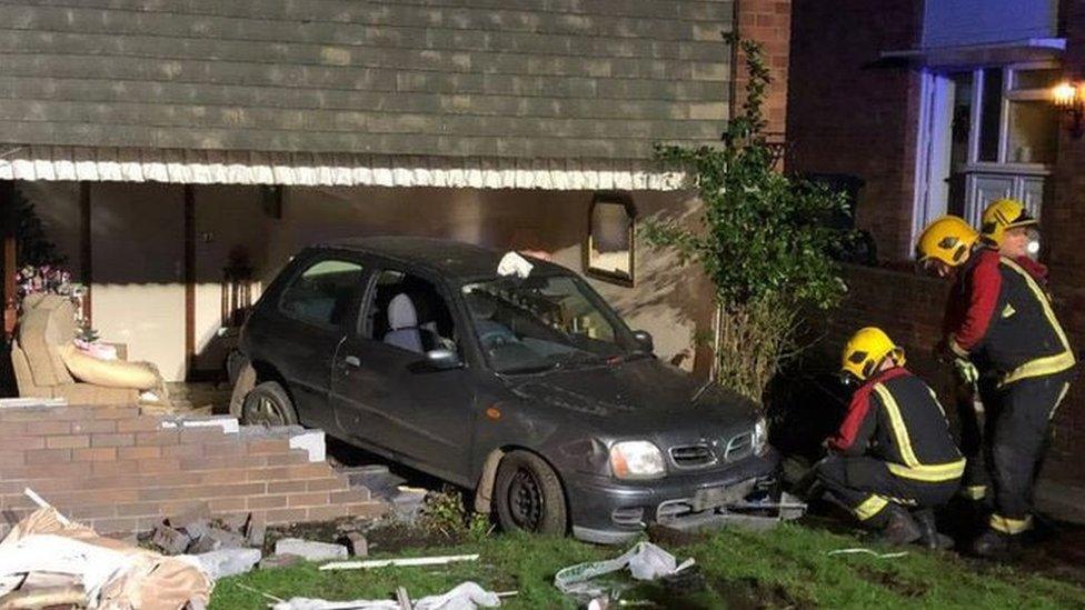 The car embedded in the wall of the house