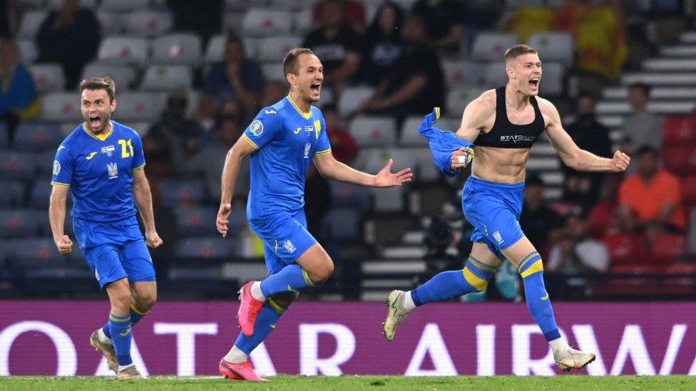 Ukraine player Artem Dovbyk (r) celebrates after scoring the winning goal during the UEFA Euro 2020 Championship Round of 16 match between Sweden and Ukraine at Hampden Park on June 29, 2021 in Glasgow, Scotland.