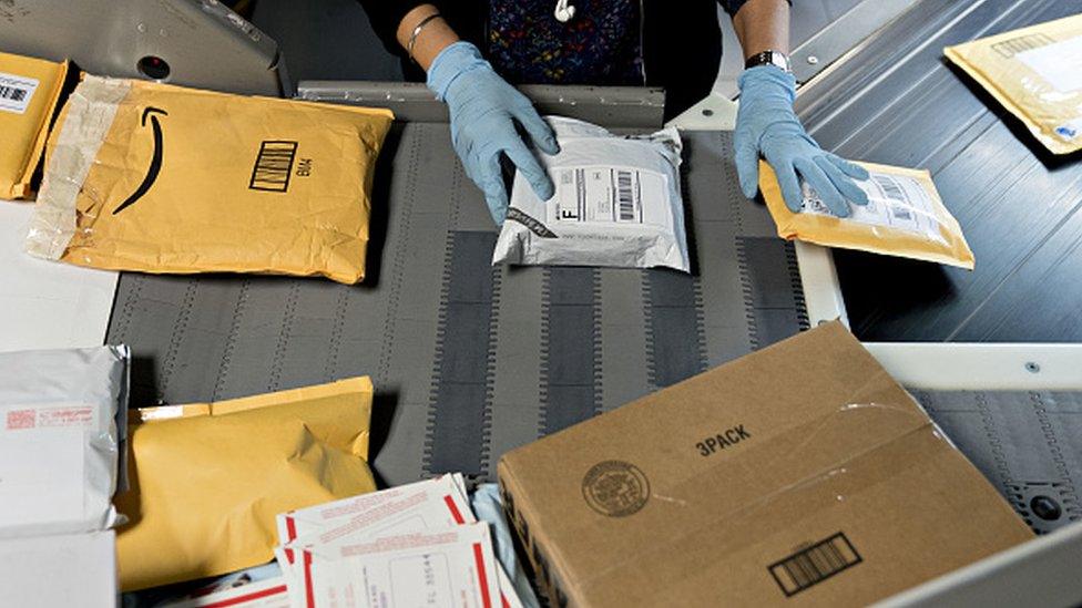 A mail handler at a delivery warehouse