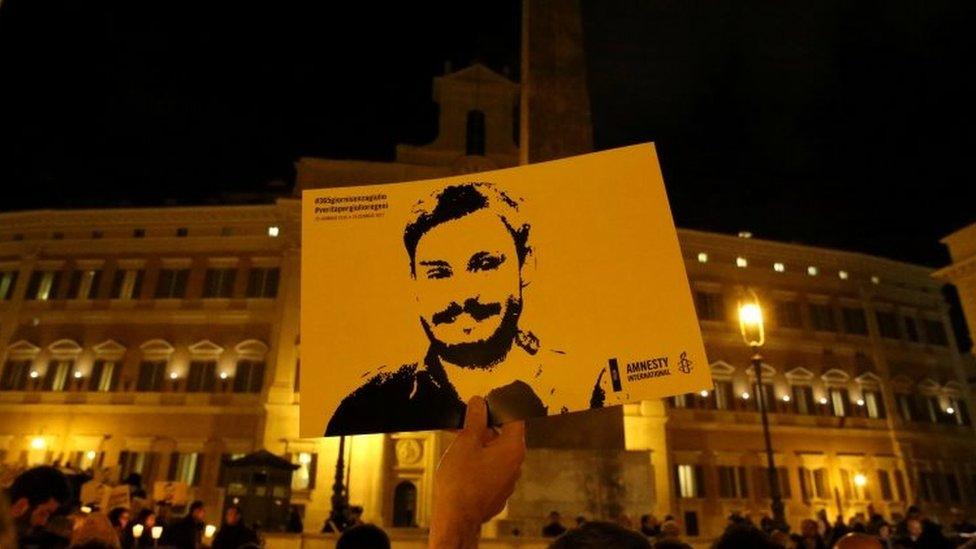 Demonstration on second anniversary, someone holds an image of Regeni