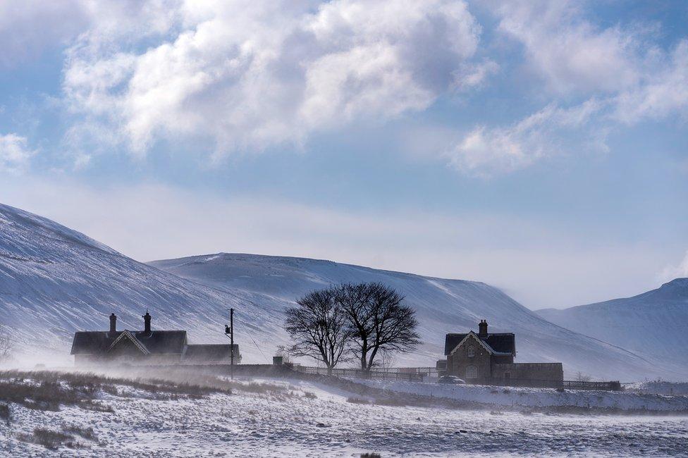 The sun shines over the snow covered dales of Ribble Valley near Ribblehead