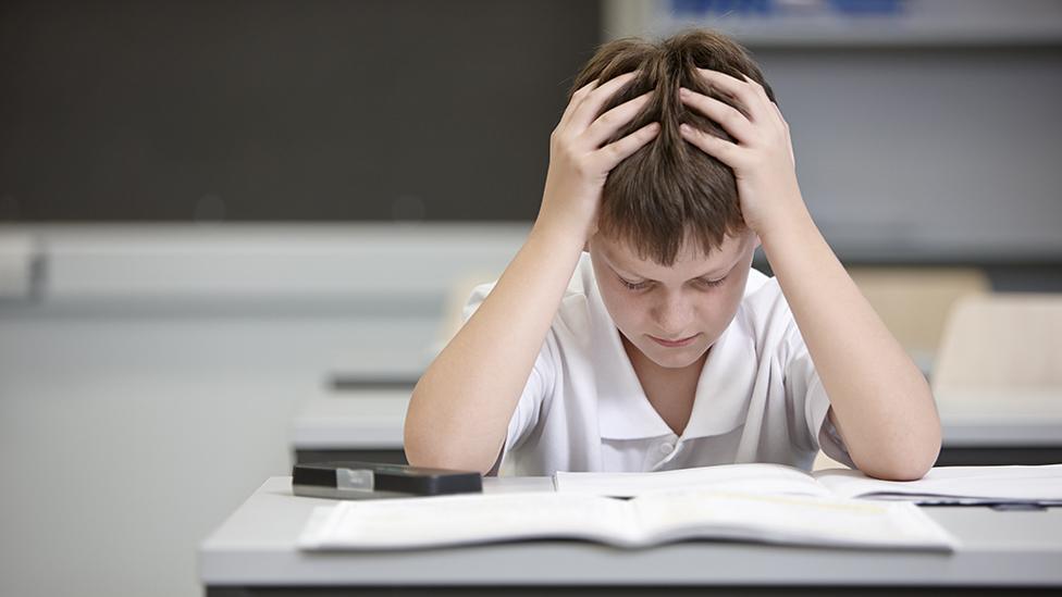 schoolboy concentrating on his work