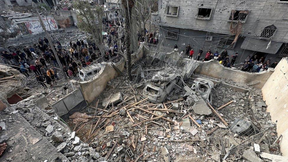 People inspect the site of an Israeli strike on a house in Jabalia, in the northern Gaza Strip, on Wednesday