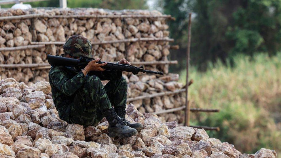 A Thai military personnel stands guard near the Thai-Myanmar border in Mae Sot, Thailand on April 11, 2024. Myanmar ethnic rebels and civilian militia took over from the military forces the town of Myawaddy, a crucial trade hub near the Thai border.