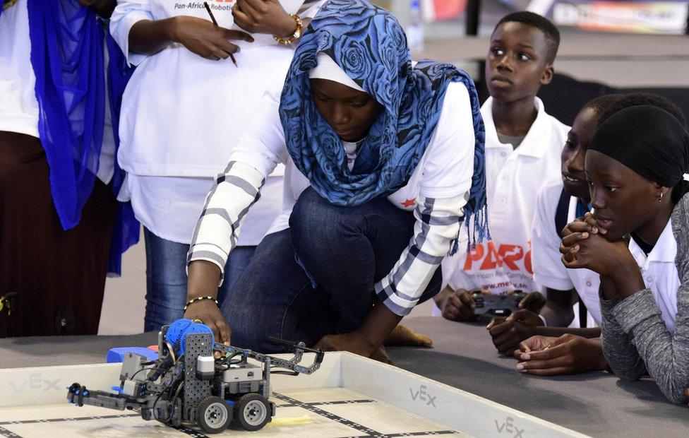 A competitor prepares a robot during the final of the national robotics competition