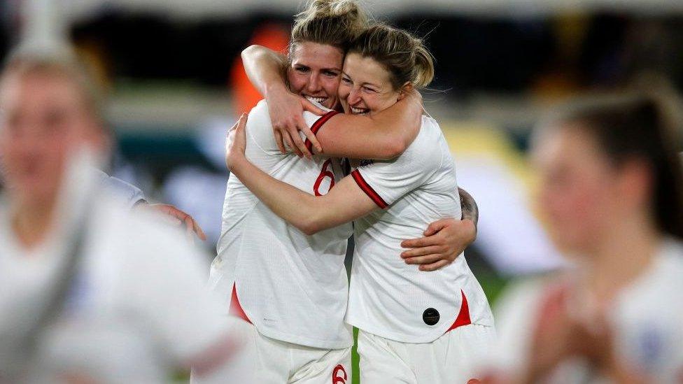 Millie Bright, left, hugs Ellen White