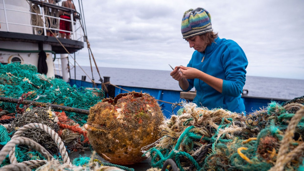 Researcher collecting debris in the Great Pacific Garbage Patch