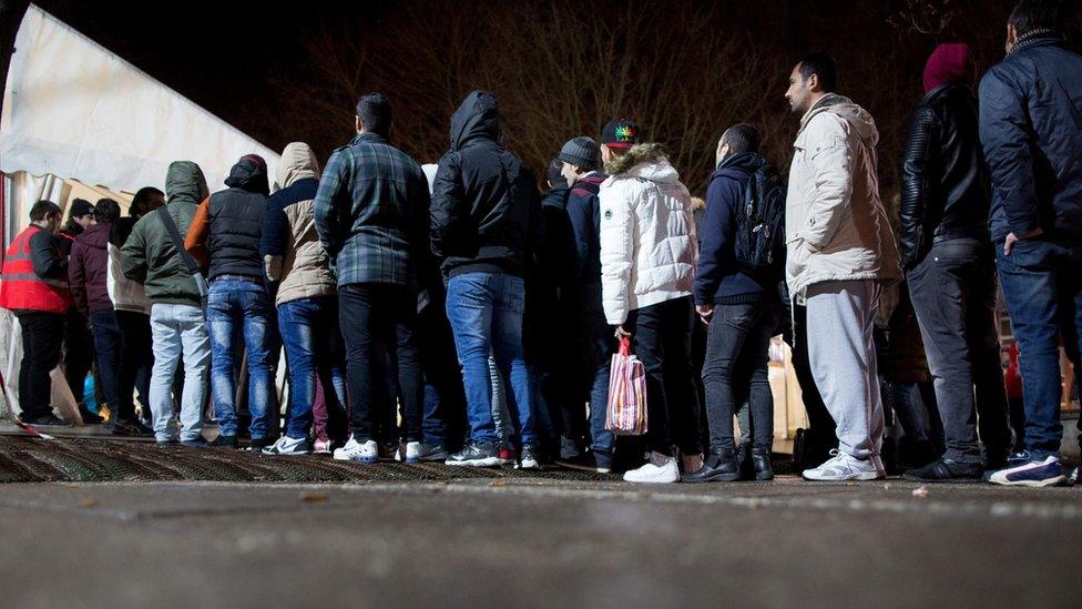 Asylum seekers queue up in Berlin at a registration centre in Berlin