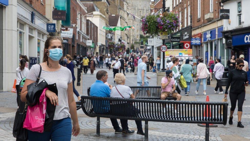 People wearing masks while out shopping