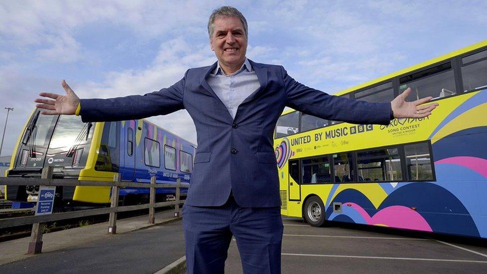 Steve Rotheram in front of the Eurovision buses