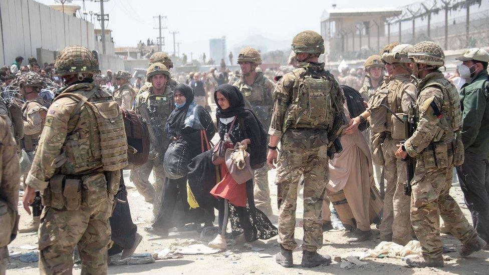 Members of the British and US military engaged in the evacuation of people out of Kabul