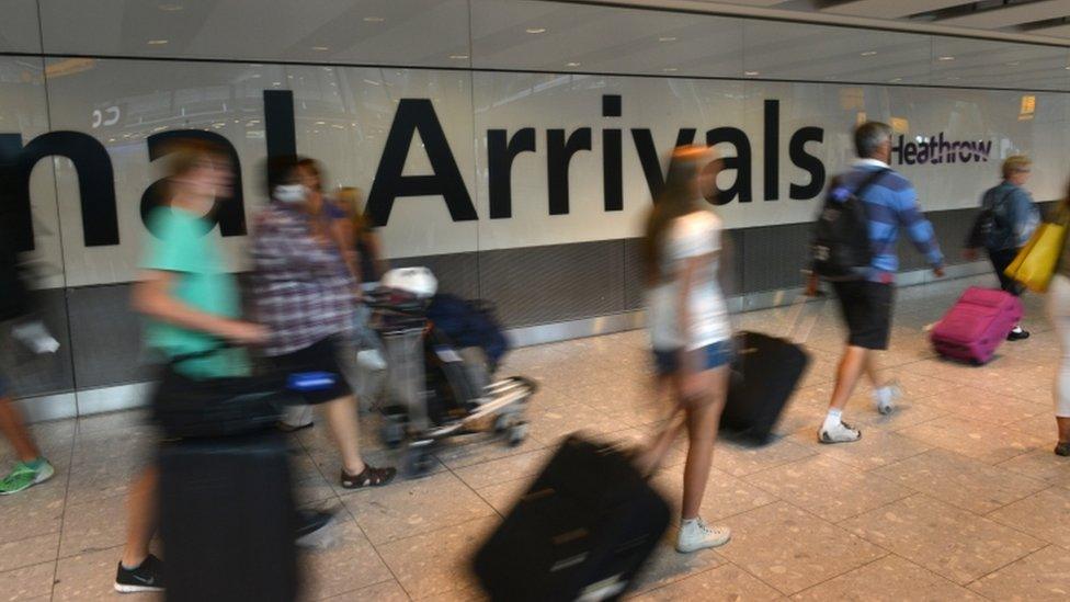 Passengers walking through Arrivals at Heathrow