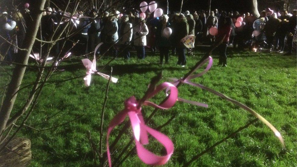 Ribbons tied around trees at vigil